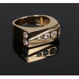 A gentleman's 14 carat gold and diamond ring. With asymetrical shank set with eight graduated