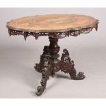 A 19th century Black Forest mahogany centre table. With marquetry panels depicting hunting scenes