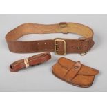 A World War I Sam Browne stitched leather belt with brass furniture along with pouch and cross belt.