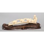 A Japanese Meiji period carved ivory tusk. Formed as a young boy chasing a train of four geese.