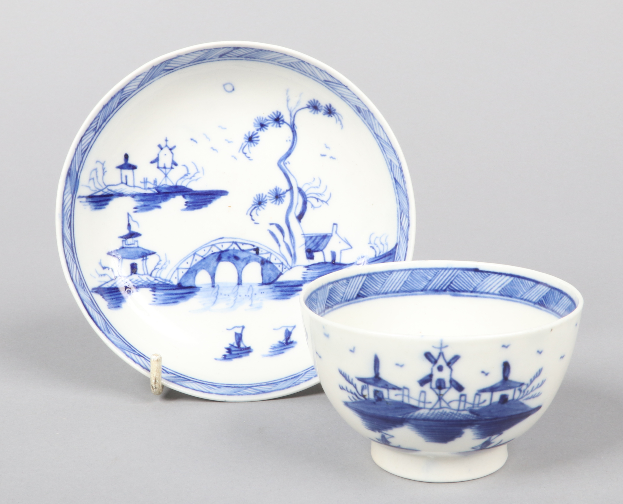 a Caughley teabowl and saucer. Painted in underglaze blue with the Bridge and Windmill pattern c. - Image 2 of 2