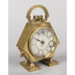A brass cased table clock with carrying loop incorporating a compass. Having silvered dial with