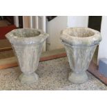 A pair of Victorian Gothic revival carved stone planters of tapering octagonal form and raised on an