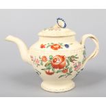 An 18th century creamware teapot and cover. With convolvulus formed knop, gadrooned mouldings,