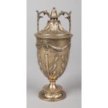 A George V silver and silver gilt lidded twin handled pedestal urn. Decorated with stiff leaves