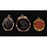 Three 19th century gold mounted hardstone fobs. Including an 18 carat gold mounted Tiffany & Co.