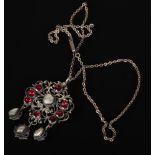 A Continental white metal pendant necklace of openwork form set with mabe pearls and garnets.