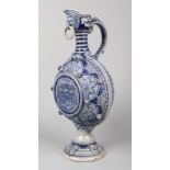 A German Westerwald very large stoneware ewer. Blue glazed and moulded with Gothic strapwork and