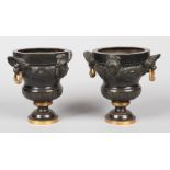 A pair of 19th century French bronze urns in Neo-Classical style. With gilt embellishments having