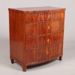 A Biedermeier mahogany bow front chest of four drawers. With inlaid escutcheons and raised on