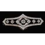 An Art Deco white gold and diamond brooch. Lozenge in form, with diamond frame and a central bar