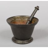 A 17th century cast bronze mortar and pestle. The mortar with everted rim and simple banded