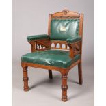 An Edwardian oak and leather boardroom armchair. With gilt coat of arms for the town of Kendal to