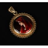 A gold mounted roundel pendant on bale. Set with a Limoges enamel portrait plaque of a young