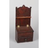 A Georgian oak and mahogany inlaid wall mounting spice box. With undulating cresting rail and