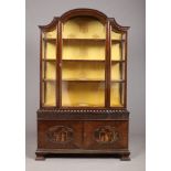 A Chinese Chippendale style mahogany dome top display cabinet. With gadrooned moulding, blind fret