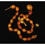 A vintage butterscotch amber graduated bead necklace each of ovoid form. Largest 20mm, gross