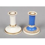 Two Rockingham miniature taper sticks, one blue ground with a trailing gilt border and gilt bands,