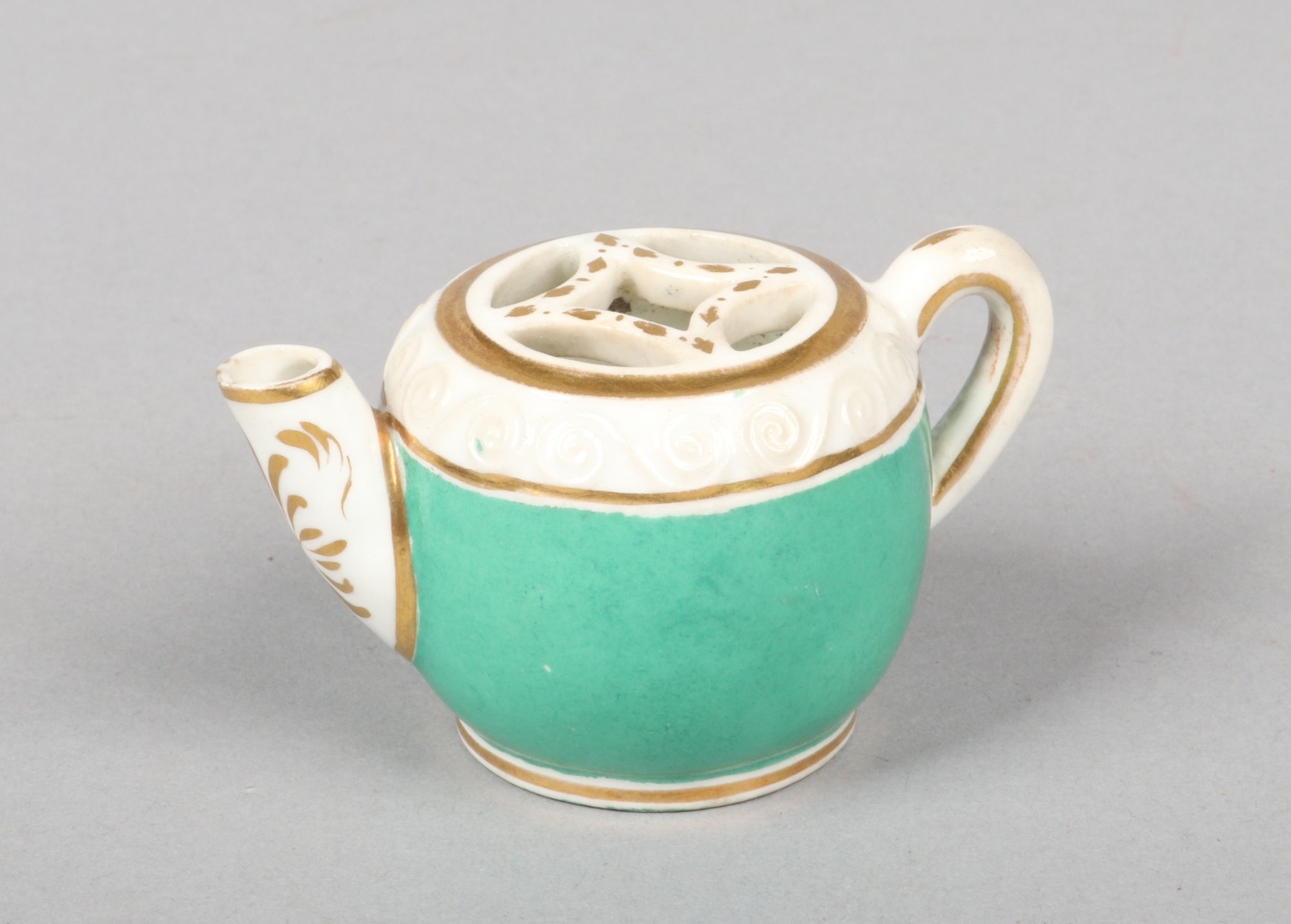 A rare Rockingham voileteer formed as a miniature teapot with pierced grill opening and scroll