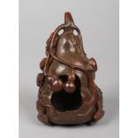 A Chinese carved bamboo brush washer. Formed as a gourd with berries and tendrils and a fruit bat,