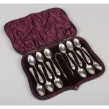 A cased set of 12 Victorian silver teaspoons and sugar tongues by Bellamy & Gordon. Assayed