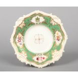 A Rockingham armorial dessert plate with shell and gadroon moulding. Having green ground border with
