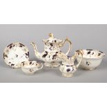 A Rockingham part tea service with single spur handles. Moulded with scrolling foliage, having wet