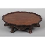 A 19th century Irish mahogany lazy Susan. With scalloped dish top, scroll and shell carved frieze