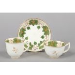 A Rockingham teacup, coffee cup and saucer of rounded type and with figure 7 handles. With green