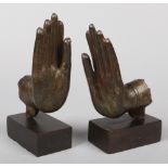 A pair of 17th or 18th century Sino Tibetan bronze Buddhistic hands formerly from a single sculpture