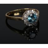 An 18 carat gold blue zircon and diamond halo cluster ring. 3.49 grams, size R.