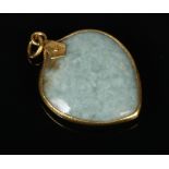 A mottled pale celadon pendant of peach form and with yellow metal mounts, 4cm. Mount ever so