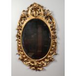 A George III oval giltwood framed pier mirror with later bevelled glass, 122cm x 76cm.