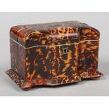 A Victorian tortoiseshell tea caddy. With serpentine front, housing two compartments, with