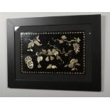 A framed 19th century Chinese lacquer panel with mother of pearl inlay depicting fruiting vines,