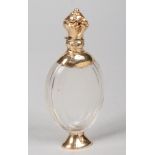 A 19th century Continental cut glass scent bottle with silver gilt mounts and hinged cover. Ovoid in