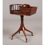 A Georgian mahogany butlers stand / dumb waiter with rotating top. Raised on a turned centre