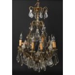 An early-mid 20th century French gilt metal and cut crystal eight branch chandelier, 90cm. Good