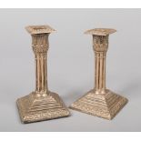 A pair of weighted silver dwarf candlesticks with detachable nozzles. Having acanthus sconces, of