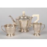 An Art Deco silver three part teaset by Joseph Gloster Ltd. Each component of stepped form and the