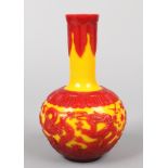 A Chinese Peking glass bottle vase. Red overlay on a yellow ground depicting dragons chasing a