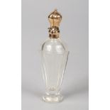 A 19th century Continental faceted glass scent bottle with silver gilt mounts and hinged cover. High