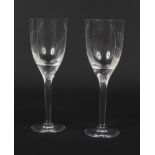 A pair of mid 20th century Lalique Angel wine glasses. With frosted mask knops and etched with wings