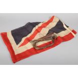 A World War I canvas union flag with rope and wooden toggle along with a copper and brass bugle