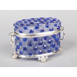 A cut glass and blue flash casket with silver plated mounts. Having ring handle and raised on ball