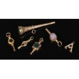 Five Victorian pinchbeck pocket watch keys including hardstone set examples and a yellow metal