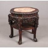A 19th century Chinese craved hardwood and marble top table of cinquefoil form. With pierced