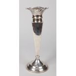 A large George V silver vase. With scalloped rim, raised on a tapering square pedestal over a