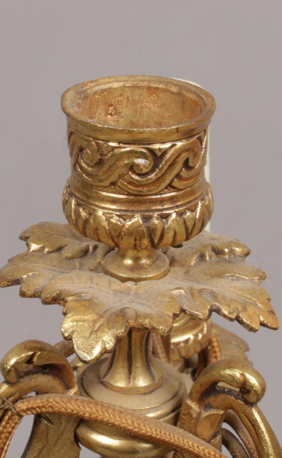 A French gilt bronze three branch tablelamp. With leaf moulded sconces and raised on a column plinth - Image 3 of 5