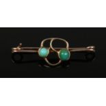 A 9ct bar brooch set with turquoise by Murrle Bennet & Co. Marked to the pin34mm wide. Slight